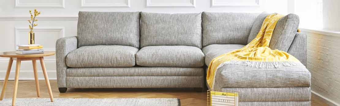 bespoke corner sofa bed in grey fabric