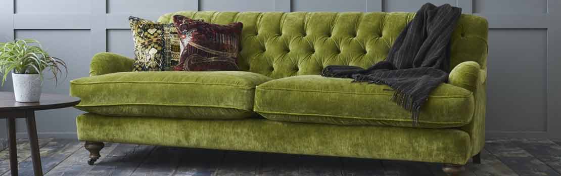 large green velvet sofa in showroom