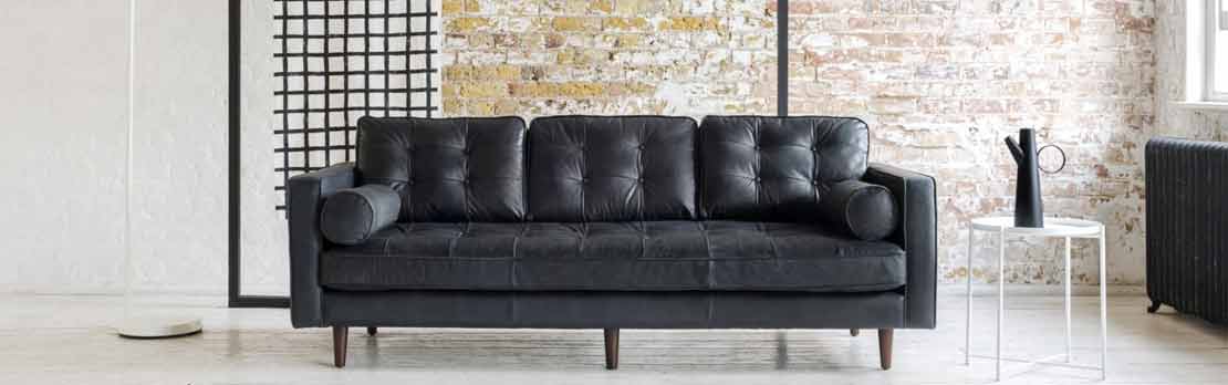 large black leather sofa in modern home