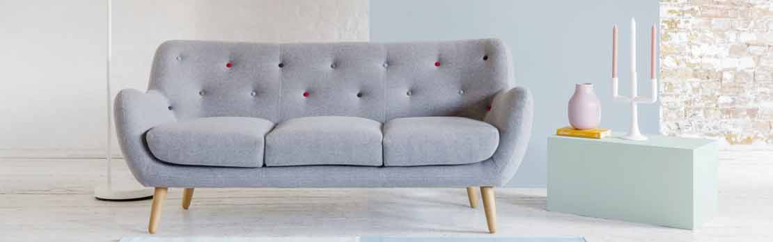 grey fabric sofa with multi colour buttons