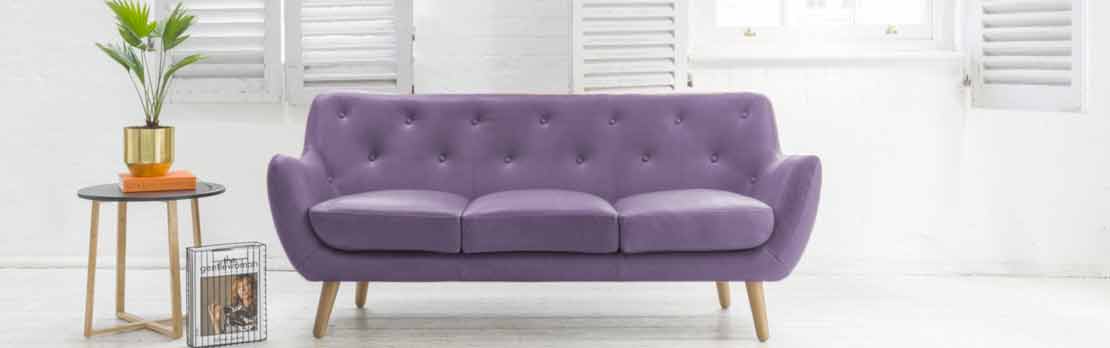 3 seater purple sofa white walled home