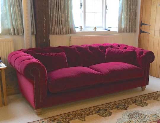 purple chesterfield sofa in living room
