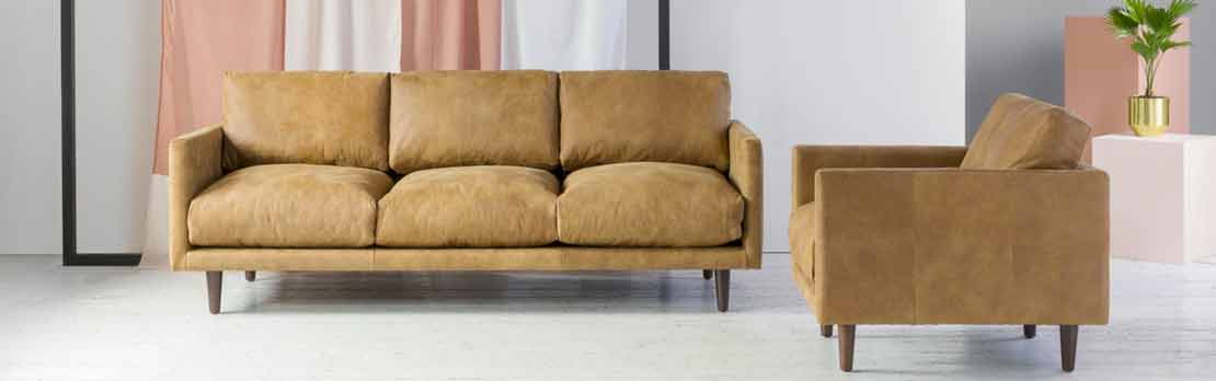 tan leather sofa and armchair in room set