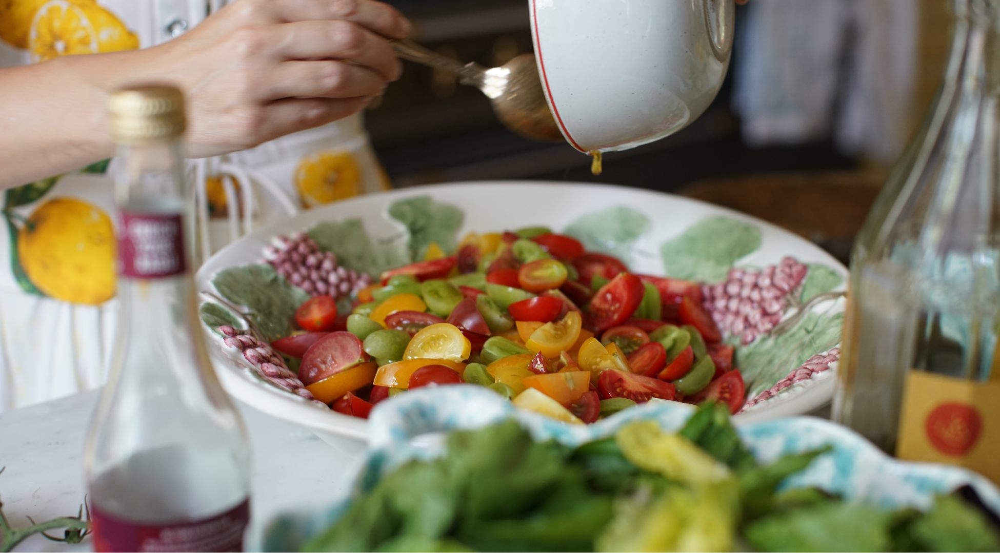 Skye pouring dressing over salad
