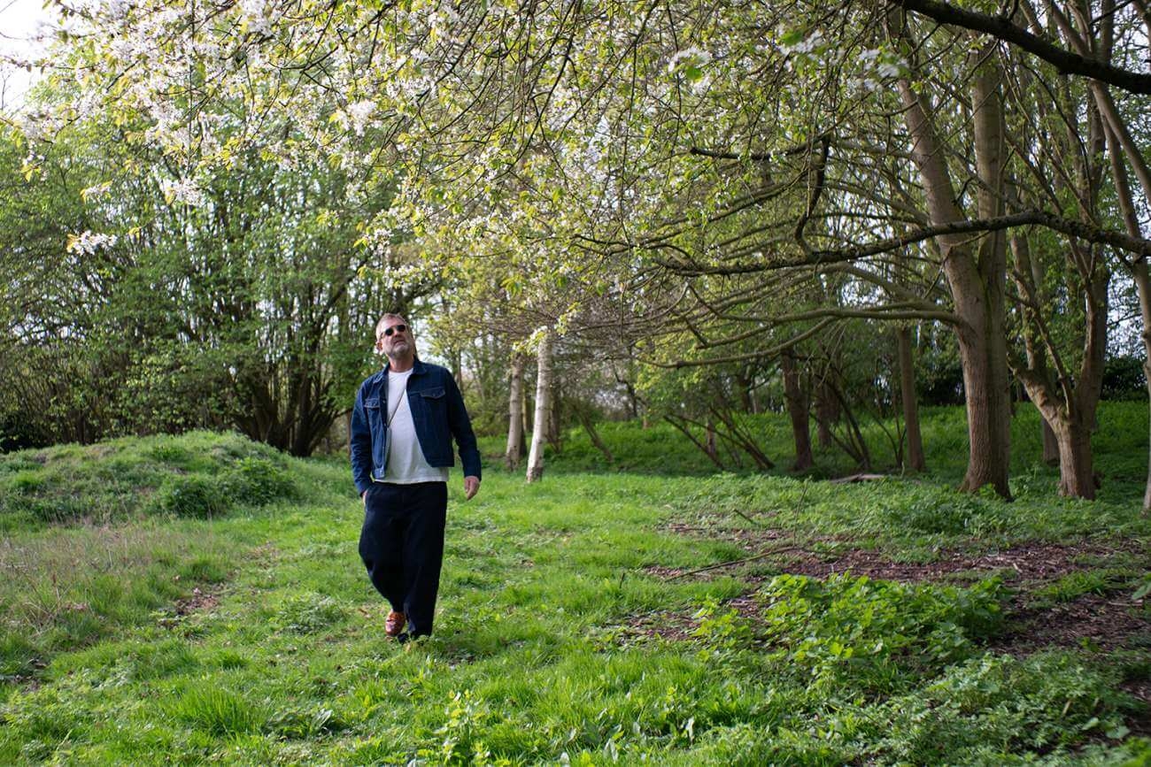 Andrew Cussins walking through woods
