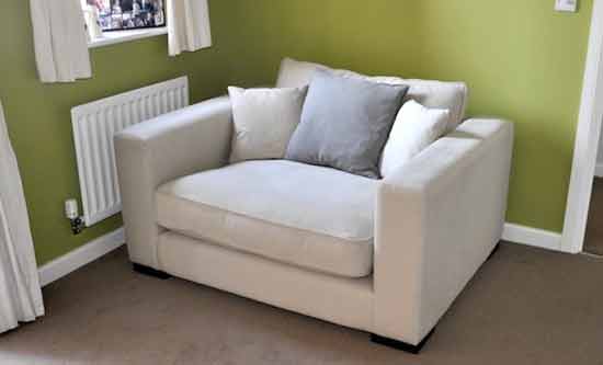 cream fabric love seat